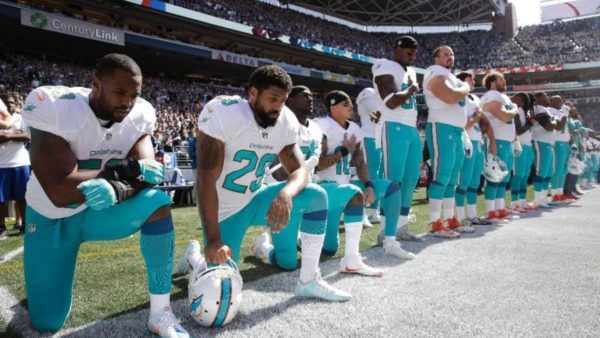 Jelani Jenkins, left, Arian Foster, Michael Thomas and Kenny Stills kneel during the National Anthem. (AP)