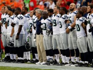 The Seahawks stand for the national anthem in 2012. Photo by Jamie Squire/Getty Images