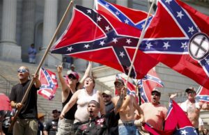 Members of the Ku Klux Klan yell as they fly Confederate flags during a rally at the statehouse in Columbia, South Carolina, July 18, 2015. Photo: Reuters/Chris Keane