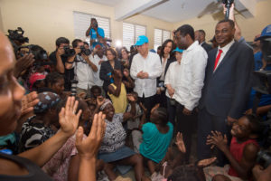 Secretary-General Ban Ki-moon (centre) visits a temporary shelter for victims of Hurricane Matthew