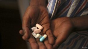 FILE - Nine-year-old Tumelo shows off antiretroviral (ARV) pills before taking his medication at Nkosi's Haven, south of Johannesburg, South Africa, Nov. 28, 2014. Seven million people in the country are currently living with the HIV virus.