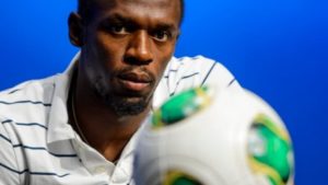 Jamaica's Usain Bolt, shown in this 2013 file photo at FIFA headquarters in Switzerland, will soon be training with Bundesliga side Borussia Dortmund. (File/AFP/Getty Images)