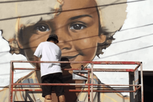 Artist Royal Dog paints Black girl in mural (@royaldog_ Instagram)