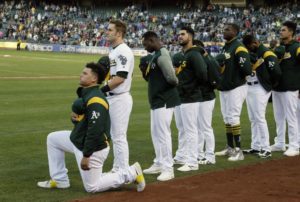 Bruce Maxwell kneels during the national anthem 