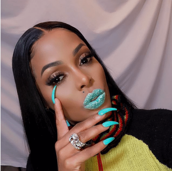 Keyshia Ka'Oir rocks teal blue lipsticks. @keyshiakaoir/Instagram
