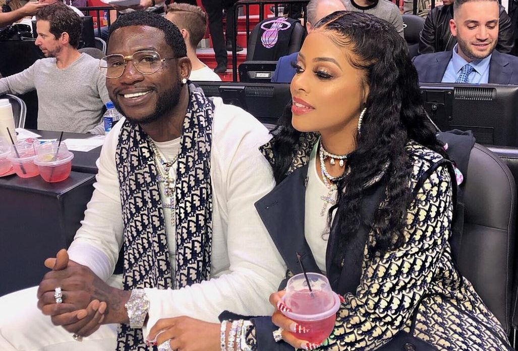 Keyshia Ka'Oir, left, wife of rapper Gucci Mane, right, pose for  photographs at courtside prior to the NBA All-Star Game at Spectrum Center  in Charlotte, N.C. on Sunday, February 17, 2019. (Photo