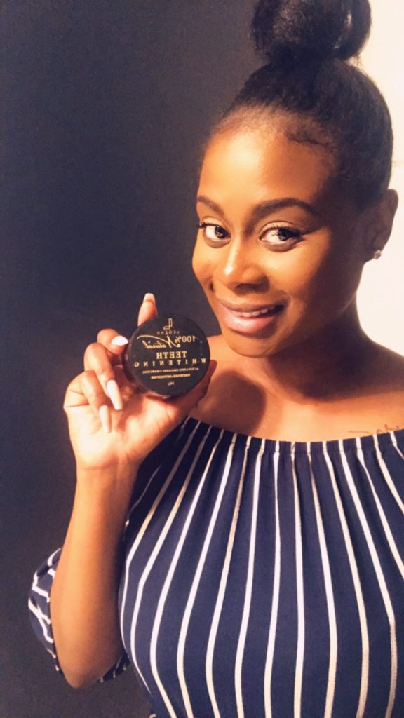 Founder poses with charcoal beauty product