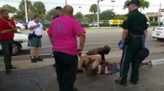 Footage of man bleeding being helped