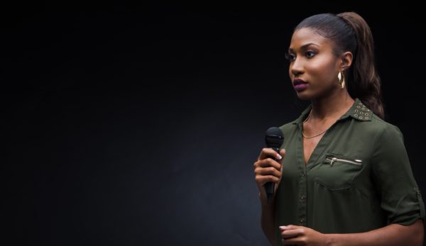 Woman with mic with black background