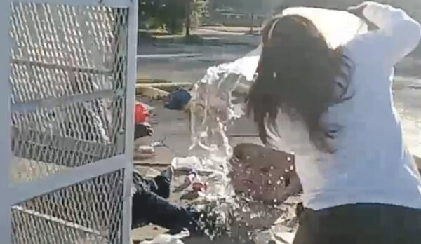 Louisiana woman pouring water on homeless person