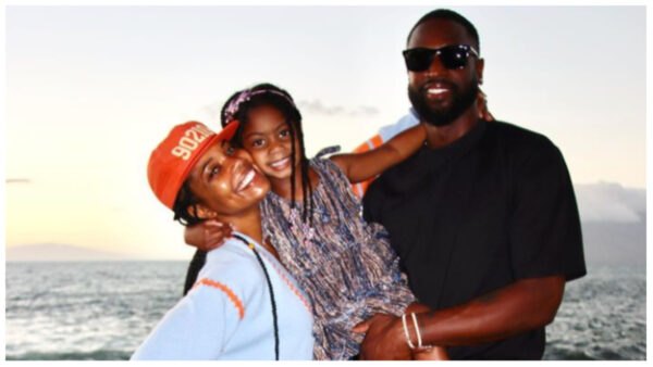 Gabrielle Union and Dwyane Wade posing with their five-year-old daughter, Kaavia James Wade. 