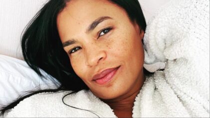 Fans say Nia Long is 'acting bad' after she's seen licking chocolate from a man's cup.