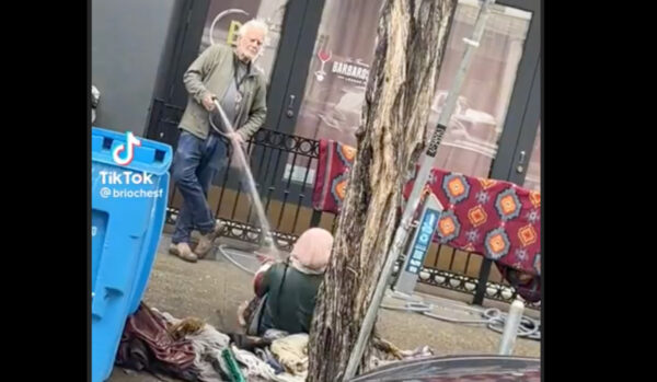 White San Francisco business owner caught spraying homeless woman with hose.