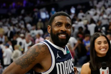 Kyrie Irving of the NBA Dallas Mavericks signs his dad to a shoe deal