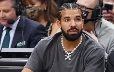 TORONTO, ON - MARCH 18: Rapper Drake reacts at the NBA game between the Toronto Raptors and the Los Angeles Lakers at Scotiabank Arena on March 18, 2022 in Toronto, Canada. NOTE TO USER: User expressly acknowledges and agrees that, by downloading and or using this Photograph, user is consenting to the terms and conditions of the Getty Images License Agreement. (Photo by Cole Burston/Getty Images)