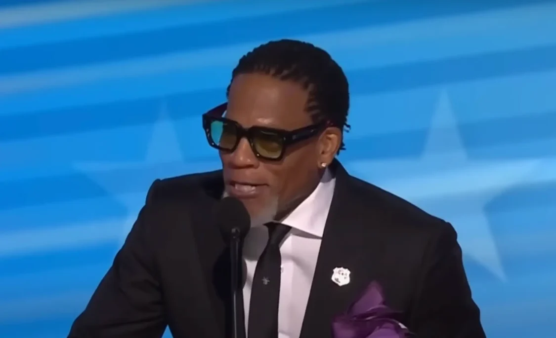 DL Hughley joins Steve Harvey in a speech about allegations that Democrats bribed him to appear at the DNC after Hughley apologized for spreading misinformation about Kamala Harris (Photo: CBS News/YouTube)