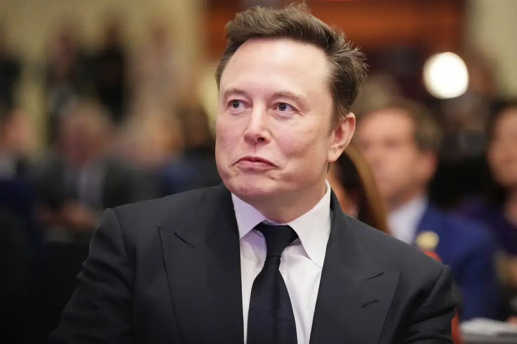 WASHINGTON, DC - NOVEMBER 13: Elon Musk listens as U.S. President-elect Donald Trump addresses a House Republicans Conference meeting at the Hyatt Regency on Capitol Hill on November 13, 2024 in Washington, DC. As is tradition with incoming presidents, Trump is traveling to Washington, DC to meet with U.S. President Joe Biden at the White House as well as meet with Republican congressmen on Capitol Hill. (Photo by Andrew Harnik/Getty Images)