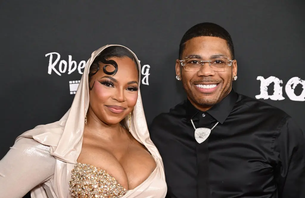 LOS ANGELES, CALIFORNIA - FEBRUARY 18: (L-R) Actor/singer Ashanti and singer Nelly attend the Los Angeles premiere of Robert Craig Films' "No Address" at DGA Theater Complex on February 18, 2025 in Los Angeles, California. (Photo by Michael Tullberg/Getty Images)