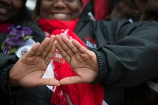 WASHINGTON DC: MARCH 03 The symbol of Delta Sigma Theta Sorority, Inc is displayed for the camera in Washington, D.C. on March 03, 2013. Deltas gathered on the West Front of the United States Capitol and then marched past the White House and finally ended their march on the grounds of the Washington Monument. Members of Delta Sigma Theta Sorority, Inc., the single largest predominantly African-American women's organization in the country, retraced the footsteps of their founders who participated in the Women's Suffrage March of 1913. Thousands of the Sorority's members accompanied by other invited organizations, to commemorate the 100th anniversary of the role the 22 Founders of Delta Sigma Theta Sorority played in the 1913 Women's Suffrage March. Guided by the event's theme, "Tracing the Footsteps of our Founders," members of the Sorority will follow the symbolic route down Pennsylvania Avenue, and assembled on the grounds of the Washington Monument. (Photo by Marvin Joseph/The Washington Post via Getty Images)