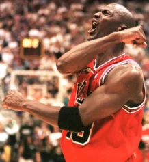 Michael Jordan of the Chicago Bulls celebrates 14 June after winning game six of the NBA Finals against the Utah Jazz at the Delta Center in Salt Lake City, UT. The Bulls won the game 87-86 to win their sixth NBA Championship. AFP PHOTO/Robert SULLIVAN (Photo by ROBERT SULLIVAN / AFP) (Photo credit should read ROBERT SULLIVAN/AFP via Getty Images)