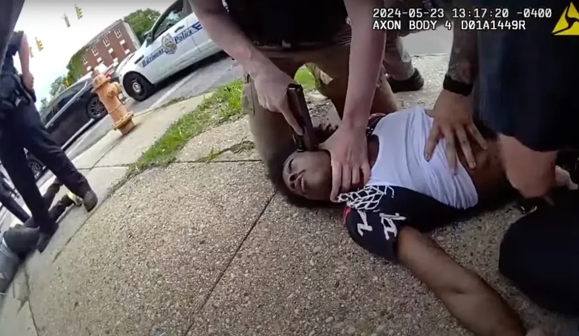 Baltimore Cop Presses Gun to Black Man's Head As He's Pinned on Sidewalk During Mistaken Identity Arrest Then Avoids Criminal Charges