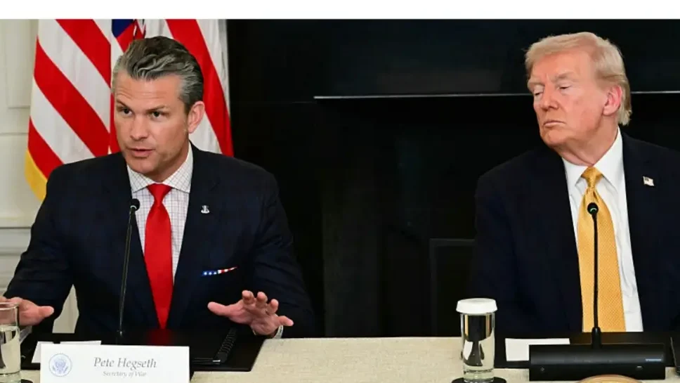 US President Donald Trump listens to Defense Secretary Pete Hegseth during a law enforcement roundtable in the State Dining Room of the White House on October 23, 2025 in Washington, DC. (Photo by Jim WATSON / AFP) (Photo by JIM WATSON/AFP via Getty Images)