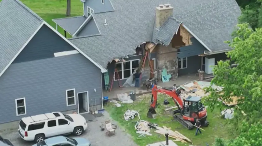 One man is accused of trying to use an excavator to tear his family's home down.