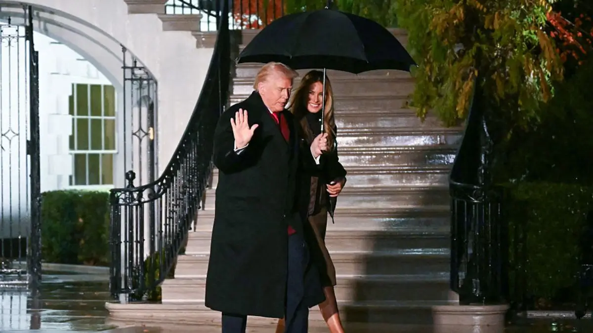 Donald Trump, 79, finally learns how to hold an umbrella over his wife's head. 